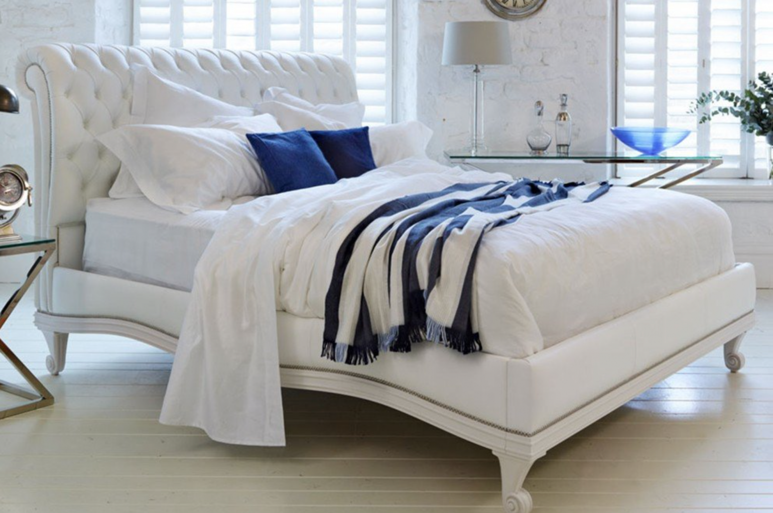White bed with blue cushions